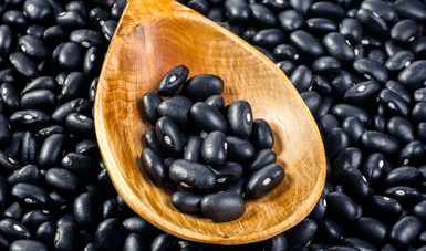 Black beans in wooden spoon for packaging and advertising professional lighting