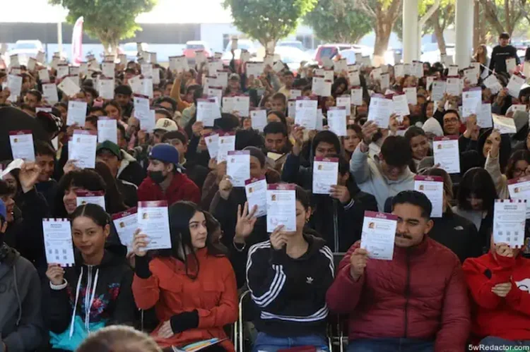 Aprendizaje masivo de estudiantes en un evento al aire libre con certificados en mano.