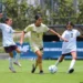 Jugadoras de fútbol femenino en acción durante un partido en el campo.