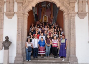 Grupo de jóvenes y facilitadores en la entrada de un edificio histórico en Michoacán, participando en un programa de Semiller.