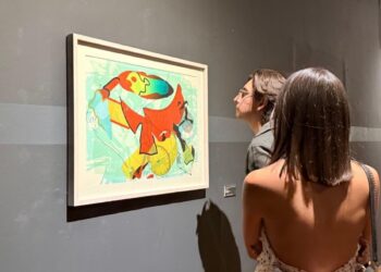 Colorful abstract painting inspired by surrealism displayed in a gallery.
