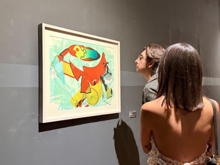 Colorful abstract painting inspired by surrealism displayed in a gallery.