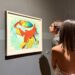 Colorful abstract painting inspired by surrealism displayed in a gallery.