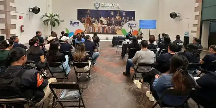 Audiencia en Zamora durante capacitación en ética pública con asistentes sentados en sillas y pantalla digital.
