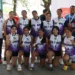 Grupo de jugadoras de voleibol con medallas y uniformes en evento deportivo en Michoacán o Jalisco.