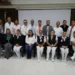 Grupo de profesionales de la salud en capacitación en Zamora, Michoacán, con fondo de pantalla y bandera mexicana.
