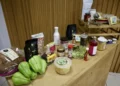 Variedad de productos orgánicos en una mesa de madera, incluyendo verduras, frascos y paquetes de alimentos naturales.