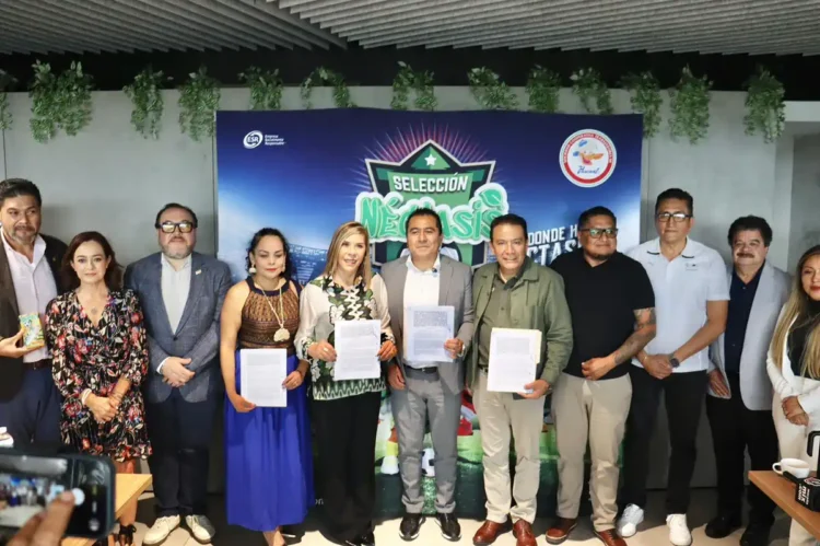 Grupo de personas en evento oficial con fondo de cartel de selección y logotipos oficiales.
